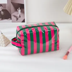 PVC striped makeup bag detail showing waterproof material, zipper closure and side handle.