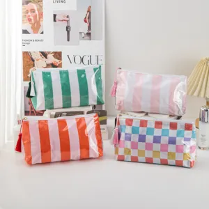 Clear PVC cosmetic bag set with colorful stripes and stylish tassel zippers for travel use.