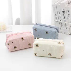 Corduroy cosmetic bag with cute bear embroidery, portable large capacity makeup storage pouch.