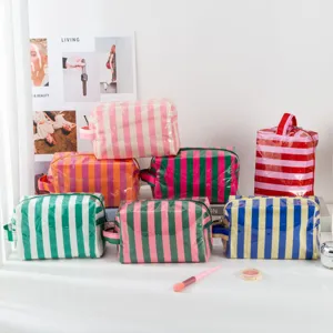 Waterproof PVC striped cosmetic bag with zipper, colorful travel toiletry bag for women and girls.