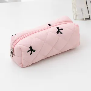 Pink quilted cosmetic bag with black bow embroidery, cute portable pencil pouch for daily storage.