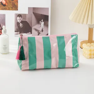 Striped PVC cosmetic bag portable travel makeup pouch waterproof storage bag with cute tassels.