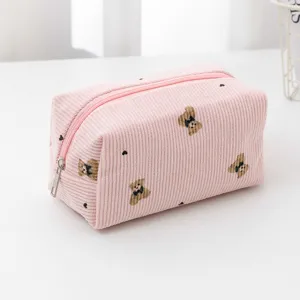 Pink corduroy cosmetic bag with cute bear embroidery and zipper closure storage.