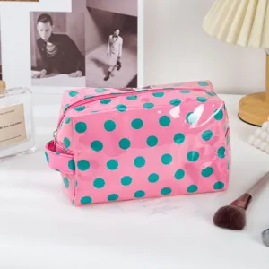 Pink and green polka dot PVC cosmetic bag, waterproof travel makeup pouch with zipper.