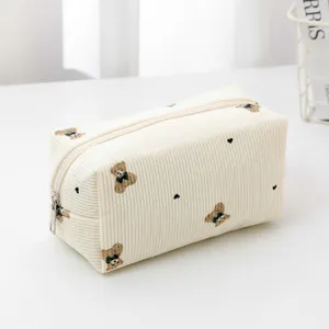 Corduroy cosmetic bag with cute bear embroidery, portable zipper storage pouch for travel.
