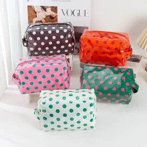 Detailed view of clear PVC polka dot cosmetic bags featuring vibrant colors and zippers.