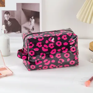 Waterproof PVC makeup bag with stylish pink leopard print, zipper and portable side handle.
