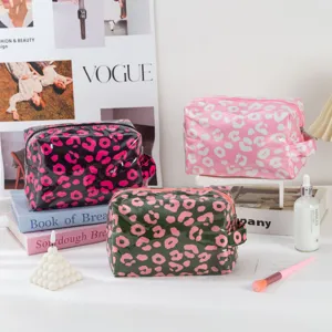 Waterproof PVC cosmetic bag with zipper and handle, stylish leopard print makeup storage pouch.