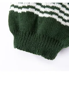 Detailed close-up of green pet sweater knit fabric with white pattern for dogs and cats.