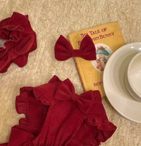 Red corduroy pet dress set with ruffles and bows for small dogs and cats in winter.