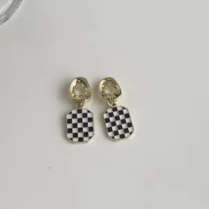 Elegant black and white checkerboard drop earrings with 14K gold plated geometric design.