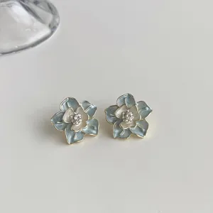 Exquisite enamel flower stud earrings detail view, sparkling rhinestone center design.