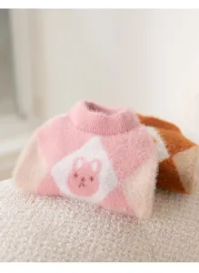 Cozy faux mink pet sweater detail shot showing pink argyle pattern and cute rabbit face.