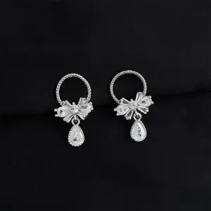Exquisite clip-on earrings featuring sparkling bow and teardrop zirconia stone detail view.