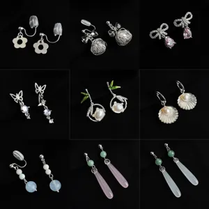 Detailed view of various elegant non-pierced clip-on earrings, featuring floral, bow, and pearl designs.