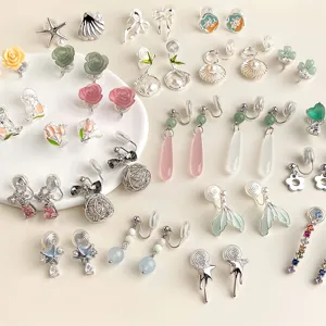 Diverse cute non-pierced clip-on earrings featuring flowers, shells, and crystal drops. Stylish jewelry.