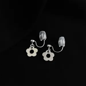 Silver flower clip-on earrings detail shot, minimalist design with clear metallic luster.