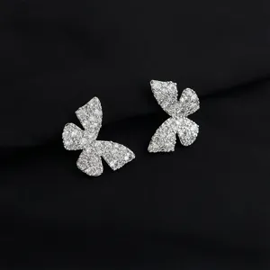 Sparkling pavé cubic zirconia butterfly ear clips detail view, elegant silver tone jewelry.
