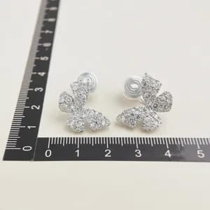 Detailed closeup of sparkling micro-paved zircon butterfly clip earrings with comfort coil design.