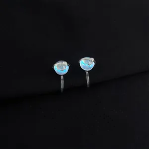 Detailed view of fashionable planet design non-piercing clip-on earrings with iridescent spheres.