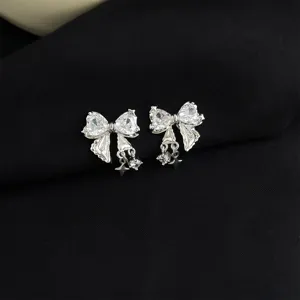 Detailed shot of sparkling micro-inlaid zircon butterfly clip-on earrings with cute dangling charms.