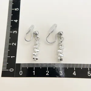 Silver tone clip-on earrings with multi-link geometric drop design, elegant jewelry.