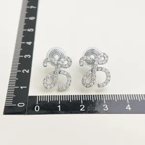Sparkling pave cubic zirconia bow clip-on earrings for non-pierced ears, elegant detail.