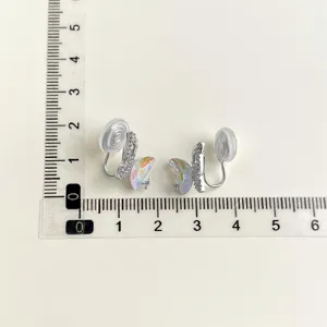 Detailed view of butterfly clip-on earrings with iridescent crystal and pavé stones.
