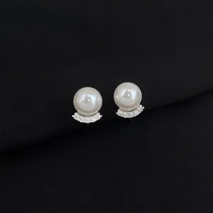 Detailed view of elegant pearl and pavé zircon ear clips, stylish and high-end jewelry.