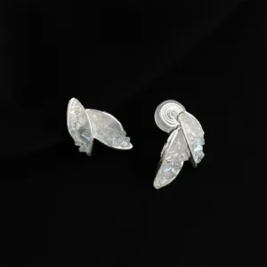 Close-up detail of silver-toned double leaf crystal clip-on earrings for non-pierced ears.