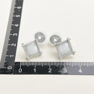 Square pave zircon clip-on earrings detail shot showing delicate stone setting and pad.