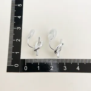 Silver metal knot clip-on earrings with minimalist geometric design and comfortable fit.