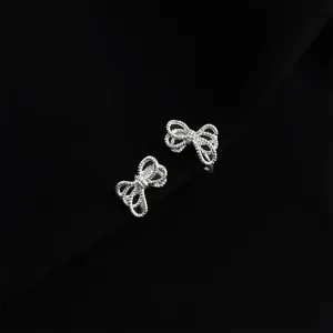 Silver bow clip-on earrings for women, non-pierced elegant daily fashion jewelry detail.
