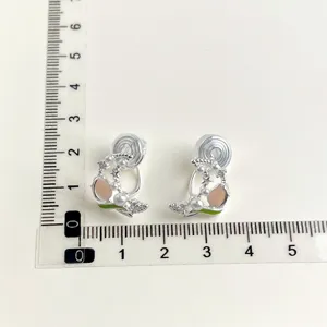 Non-pierced clip-on earrings featuring peach stone, pearls, and green leaf charms for daily wear.