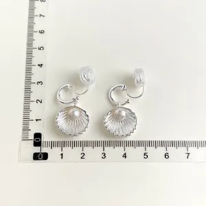 Silver shell pearl clip earrings non pierced design detailed view with size ruler display.