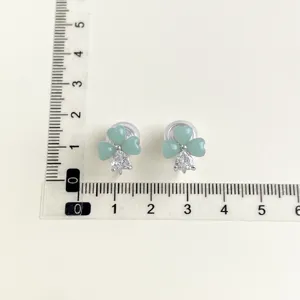 Green clover clip-on earrings with crystal drop, elegant non-piercing ear jewelry for women.