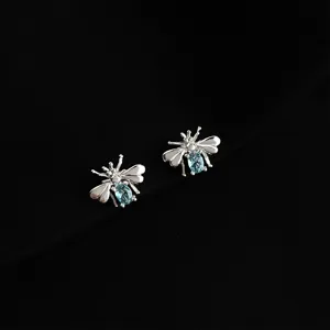 Silver bee stud earrings featuring sparkling light blue crystal bodies, elegant and stylish.