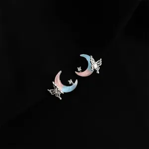 Detail shot of cute gradient pink blue moon butterfly earrings, sparkling crystal rhinestones.