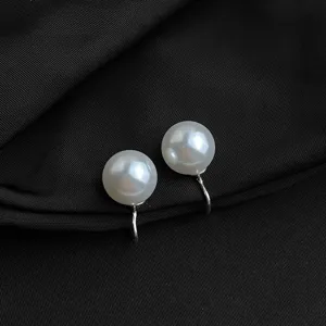Nahaufnahme von eleganten weißen Glasperlen Ohrclips mit bequemer silberner Rückseite.