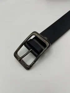 Men's casual leather belt detail showing retro bronze pin buckle and black strap.