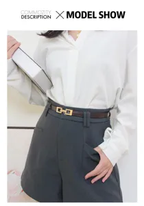 Vue détaillée d'une élégante ceinture fine en cuir avec boucle dorée sur short foncé.