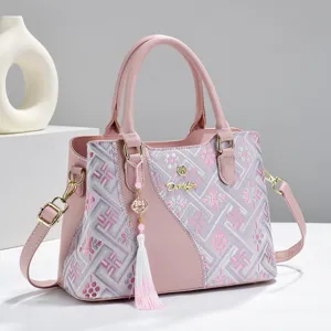 Detailed view of pink women handbag featuring traditional geometric embroidery and elegant charm.
