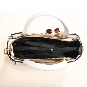 White women handbag detail view, large capacity tote bag with compartments and cherry charm.