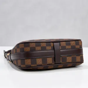 Brown monogram underarm shoulder bag bottom detail, classic patterned design for women.