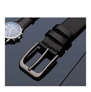 Detailed view of men's black leather belt with metal pin buckle and textured finish.