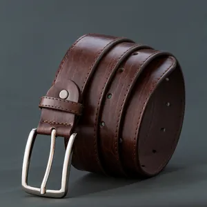 Detailed view of mens vintage pin buckle leather belt, classic brown strap and metal clasp.