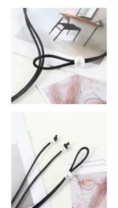 Vista detallada del elegante cinturón de cordón cuero negro con perla blanca y nudo ajustable.