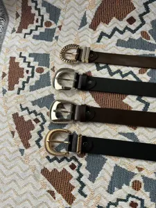 Gedetailleerd overzicht van casual lederen riem met verschillende metalen gespen in zwart bruin.