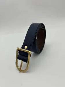 Close-up detail of dark blue women's belt with elegant gold-tone metal pin buckle texture.