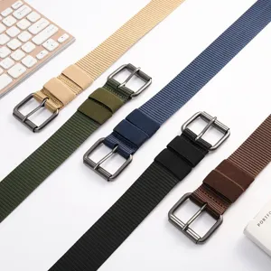 Canvas belt detail showing multi-color fabric straps and metal pin buckles for casual wear.